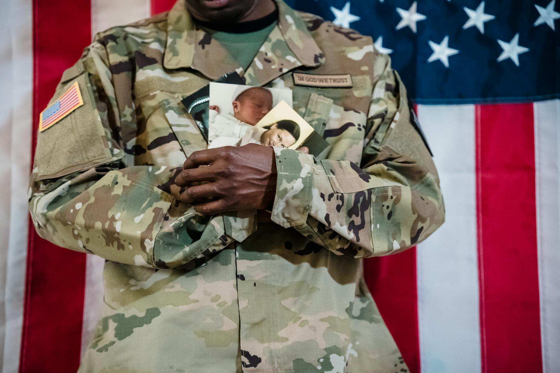 Soldier with family photos and American flag